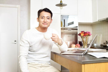 young asian man working from home
