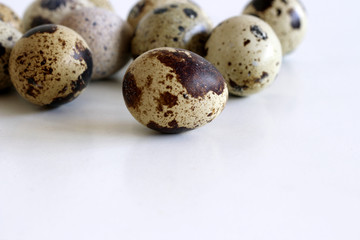 Isolated quail eggs on white background. Food concept.Quail eggs are smaller than chicken, yet they...