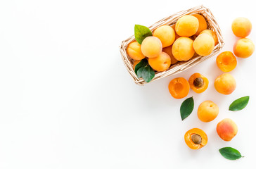 Collect apricots, white background top view copy space, pattern with leaves