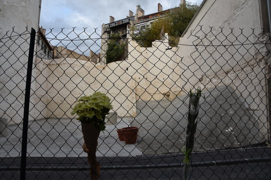 Fence with flowers in front of he site of the collapse of two residential buildings street of Aubagne, a year after the tragedy. Eight people lost their lives