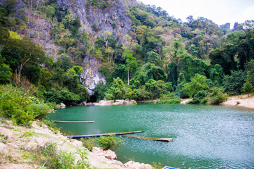 blue lagoon in front of rock mountain