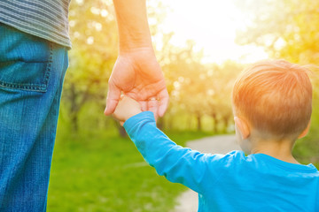 the parent holding the child's hand with a happy background