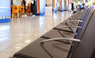 Row of empty chairs of departure hall in the airport