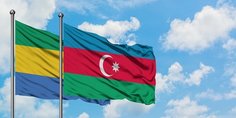 Gabon and Azerbaijan flag waving in the wind against white cloudy blue sky together. Diplomacy concept, international relations.