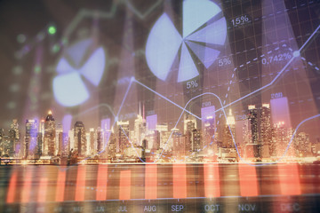 Financial graph on night city scape with tall buildings background multi exposure. Analysis concept.