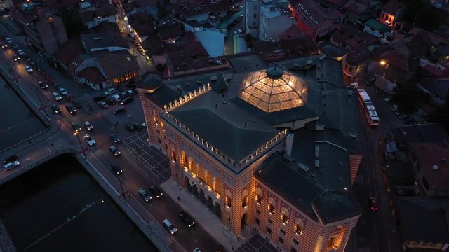 SARAJEVO, BOSNIA AND HERZEGOVINA, AUGUST 11 2019: Aerial/drone shot of Sarajevo City Hall taken during sunset. Most famous building in Sarajevo. Vijecnica