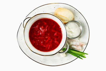 Appetizing borsch with garlic and sour cream in a plate. Traditional Russian cuisine. Top view. Isolated over white background.