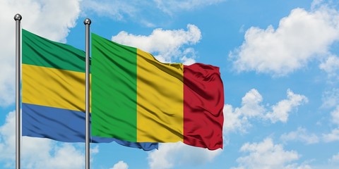 Gabon and Mali flag waving in the wind against white cloudy blue sky together. Diplomacy concept,...