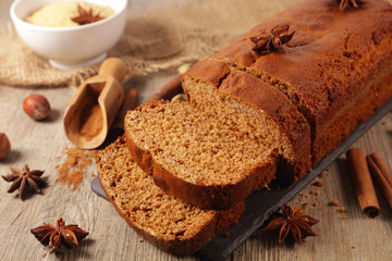 gingerbread cake with spices on wood background
