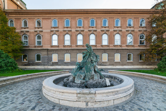 Budapest, Hungary - October 01, 2019: The Fishing Kids Fountain by K&aacute;roly Senya in the Historical Castle District in Budapest. It is listed by UNESCO as a World Heritage site, was completed in 1265.