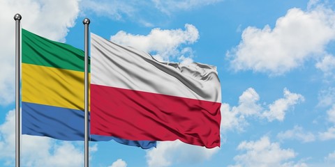 Gabon and Poland flag waving in the wind against white cloudy blue sky together. Diplomacy concept,...