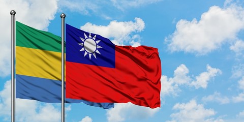 Gabon and Taiwan flag waving in the wind against white cloudy blue sky together. Diplomacy concept,...