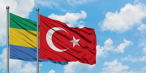 Gabon and Turkey flag waving in the wind against white cloudy blue sky together. Diplomacy concept, international relations.