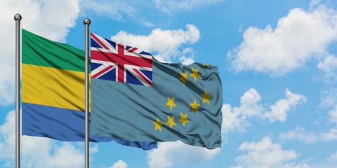 Gabon and Tuvalu flag waving in the wind against white cloudy blue sky together. Diplomacy concept,...