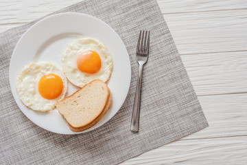 Healthy breakfast with fried eggs on wooden table