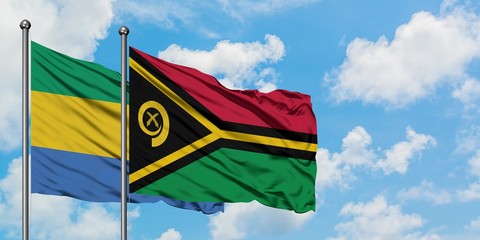 Gabon and Vanuatu flag waving in the wind against white cloudy blue sky together. Diplomacy concept, international relations.