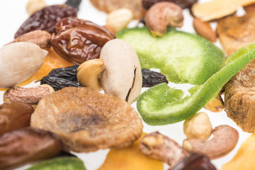 close up view of Turkish assorted nuts, dried fruits and candied fruit isolated on white