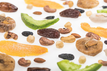 close up view of assorted nuts, dried fruits and candied fruit isolated on white
