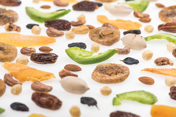 close up view of assorted nuts, dried fruits and candied fruit isolated on white