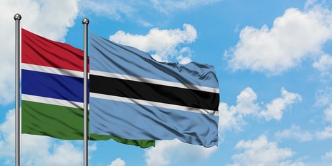Gambia and Botswana flag waving in the wind against white cloudy blue sky together. Diplomacy concept, international relations.