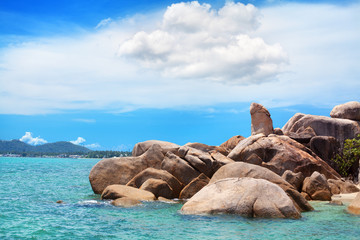 Hin Ta and Hin Yai rocks close up view, Grandmother and Grandfather stones, blue sea, sunny sky, clouds background, famous tourist natural landmark on Lamai beach, Koh Samui tropical island, Thailand