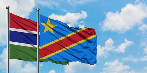 Gambia and Congo flag waving in the wind against white cloudy blue sky together. Diplomacy concept, international relations.