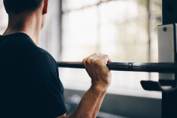 authentic image, fit man lifting weights, barbell overhead press. concept of weight loss and...