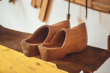 Clogs - A pair of vintage wooden shoes on a bench