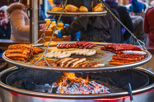 Grilling Sausages On Barbecue Grill At Christmas Market Winter Wonderland In London