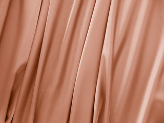 Beautiful smooth elegant wavy beige / light brown satin silk luxury cloth fabric texture, abstract...