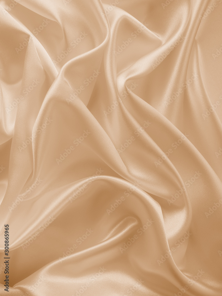 Wall mural Beautiful smooth elegant wavy beige / light brown satin silk luxury cloth fabric texture, abstract background design. Copy space.