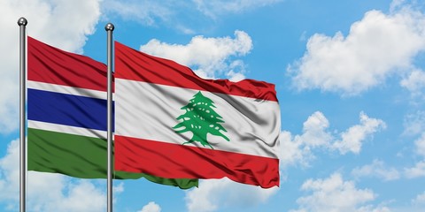 Gambia and Lebanon flag waving in the wind against white cloudy blue sky together. Diplomacy concept, international relations.