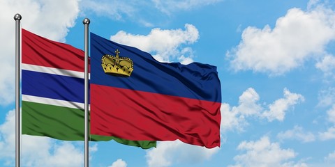 Gambia and Liechtenstein flag waving in the wind against white cloudy blue sky together. Diplomacy concept, international relations.