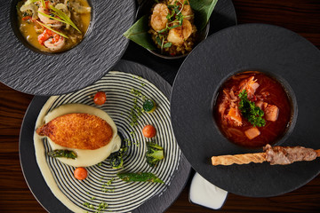 top view of delicious restaurant dishes on wooden table