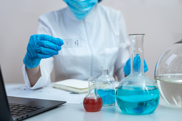 Chemist woman making laboratory research, sitting in office