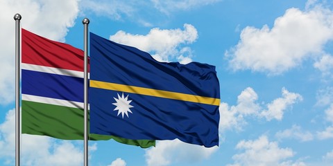 Gambia and Nauru flag waving in the wind against white cloudy blue sky together. Diplomacy concept, international relations.