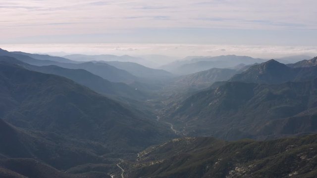 Morning fog covering the mountains and a canyon found at the base of the majestic Sierra Neveda Mountain Range in California.
