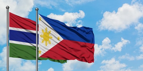 Gambia and Philippines flag waving in the wind against white cloudy blue sky together. Diplomacy concept, international relations.