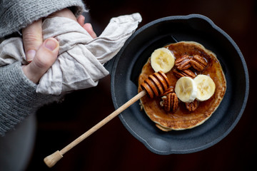 Pancakes with banana, walnuts and honey. Morning concept