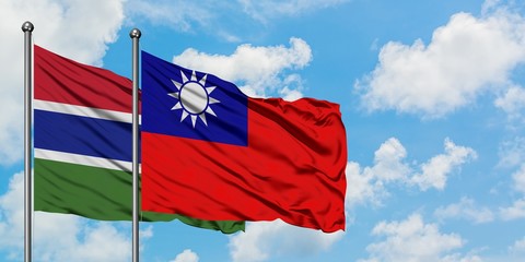 Gambia and Taiwan flag waving in the wind against white cloudy blue sky together. Diplomacy concept, international relations.