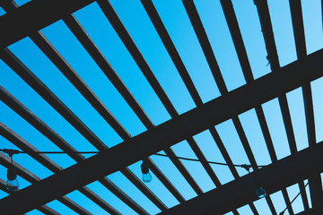 Wooden roofing in a summer garden porch roof: geometrical pattern