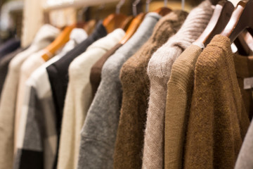 Warm winter ladies clothes(knit) on hangers.
