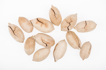 top view of whole pistachios in shell scattered isolated on white