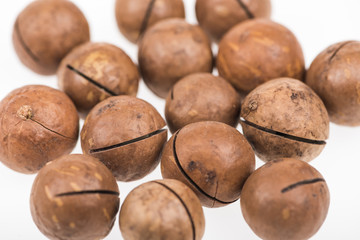 close up view of Macadamia nuts scattered isolated on white