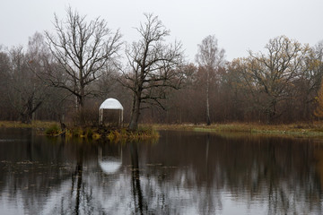 Autumn panorama of the pond with a gazebo in the Park with oaks. Smolensk region, Russia.