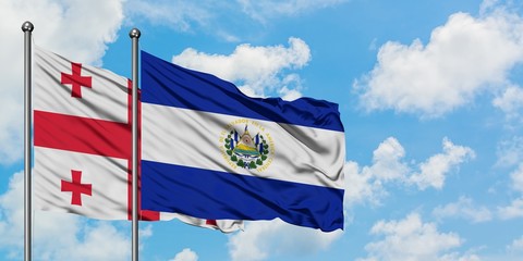 Georgia and El Salvador flag waving in the wind against white cloudy blue sky together. Diplomacy concept, international relations.