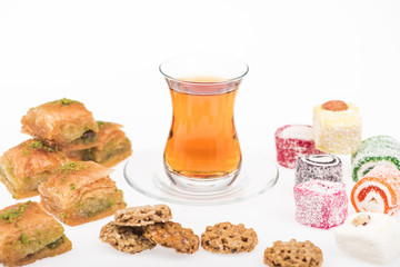 cup of tea near baklava, turkish delight and gozinaki isolated on white