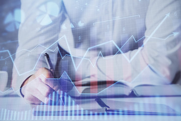 Financial trading chart multi exposure with man desktop background.