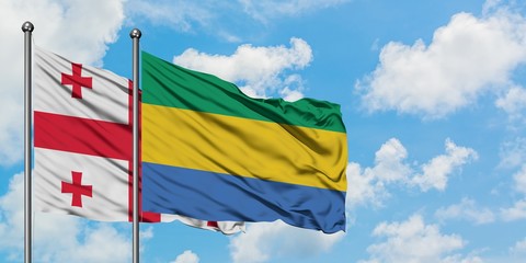 Georgia and Gabon flag waving in the wind against white cloudy blue sky together. Diplomacy concept, international relations.