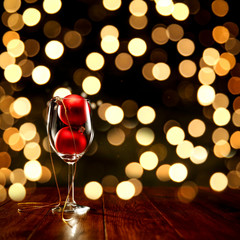 Christmas wooden table of free space for your decoration.Bokey dark background.Glasses on top with christmas balls.Copy space,New Year time,Christms Eve,Coffee table and place for your decoration.